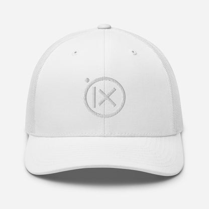 White trucker snapback cap with circular X logo patch on front