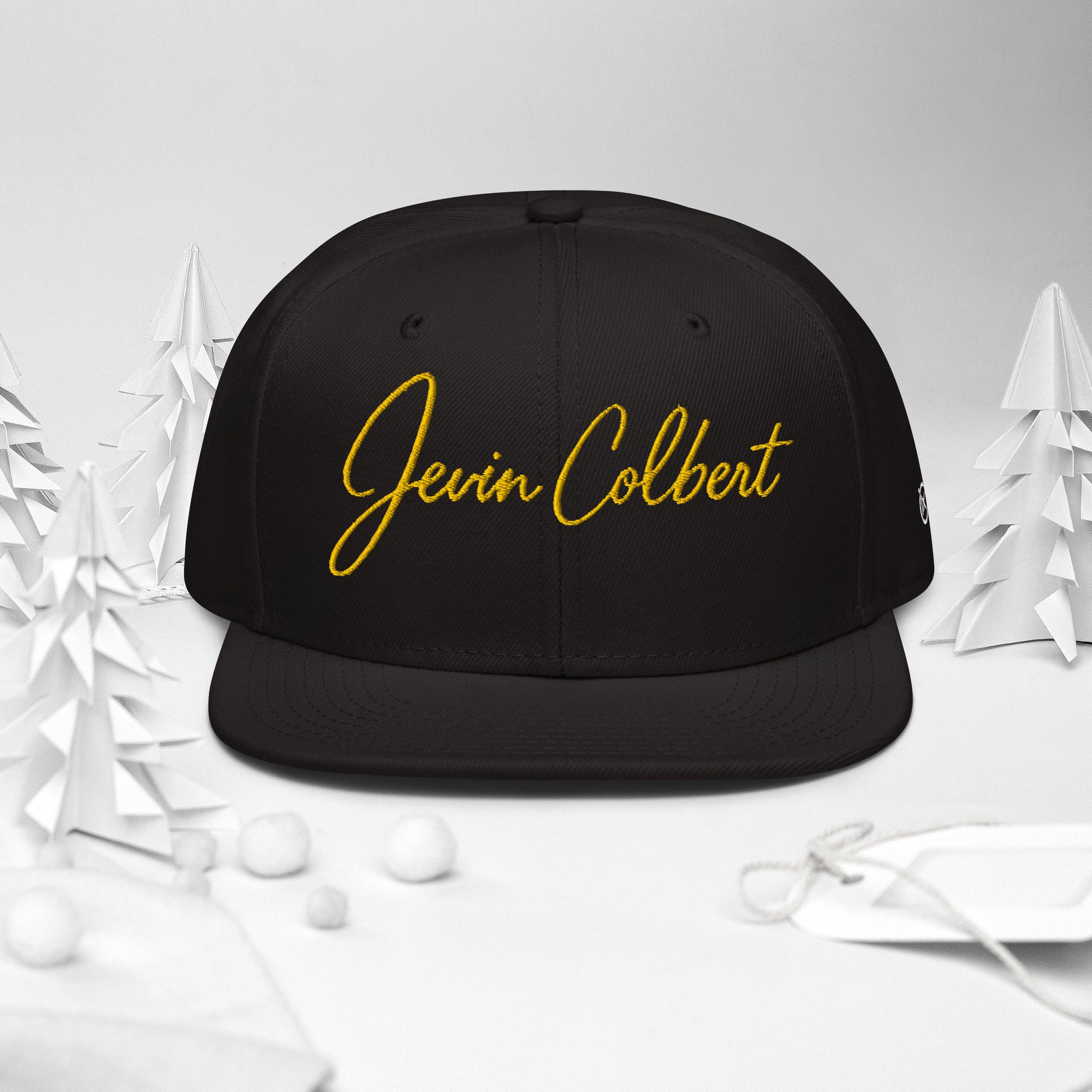 Black snapback cap with Jevin Colbert logo embroidery on the crown