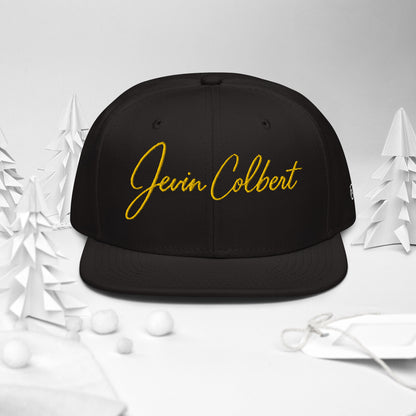 Black snapback cap with Jevin Colbert logo embroidery on the crown