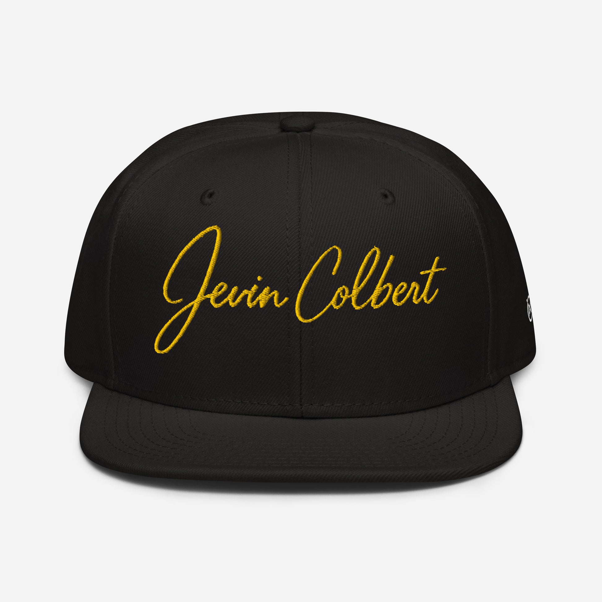 Black snapback cap with yellow “Jevin Colbert” script embroidery on the front panel