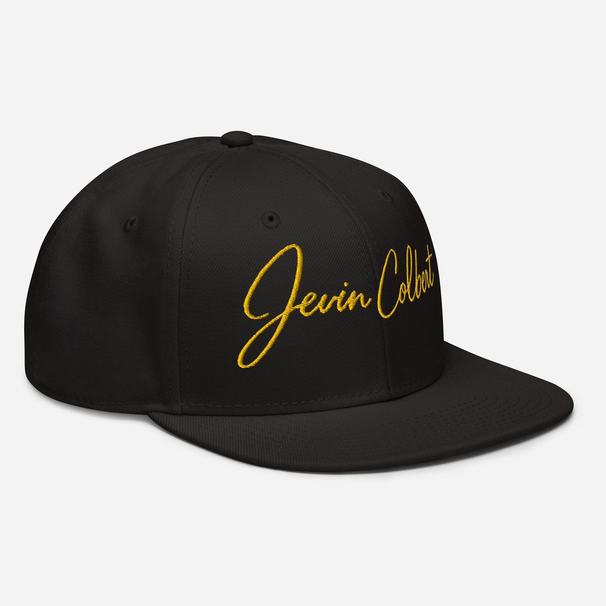 Black snapback cap with yellow “Jevin Colbert” script logo and curved brim