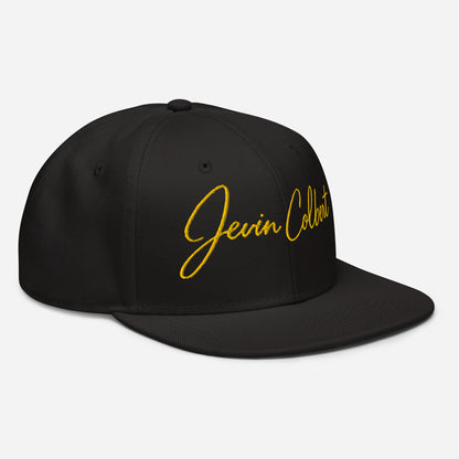 Black snapback cap with yellow “Jevin Colbert” script logo and curved brim