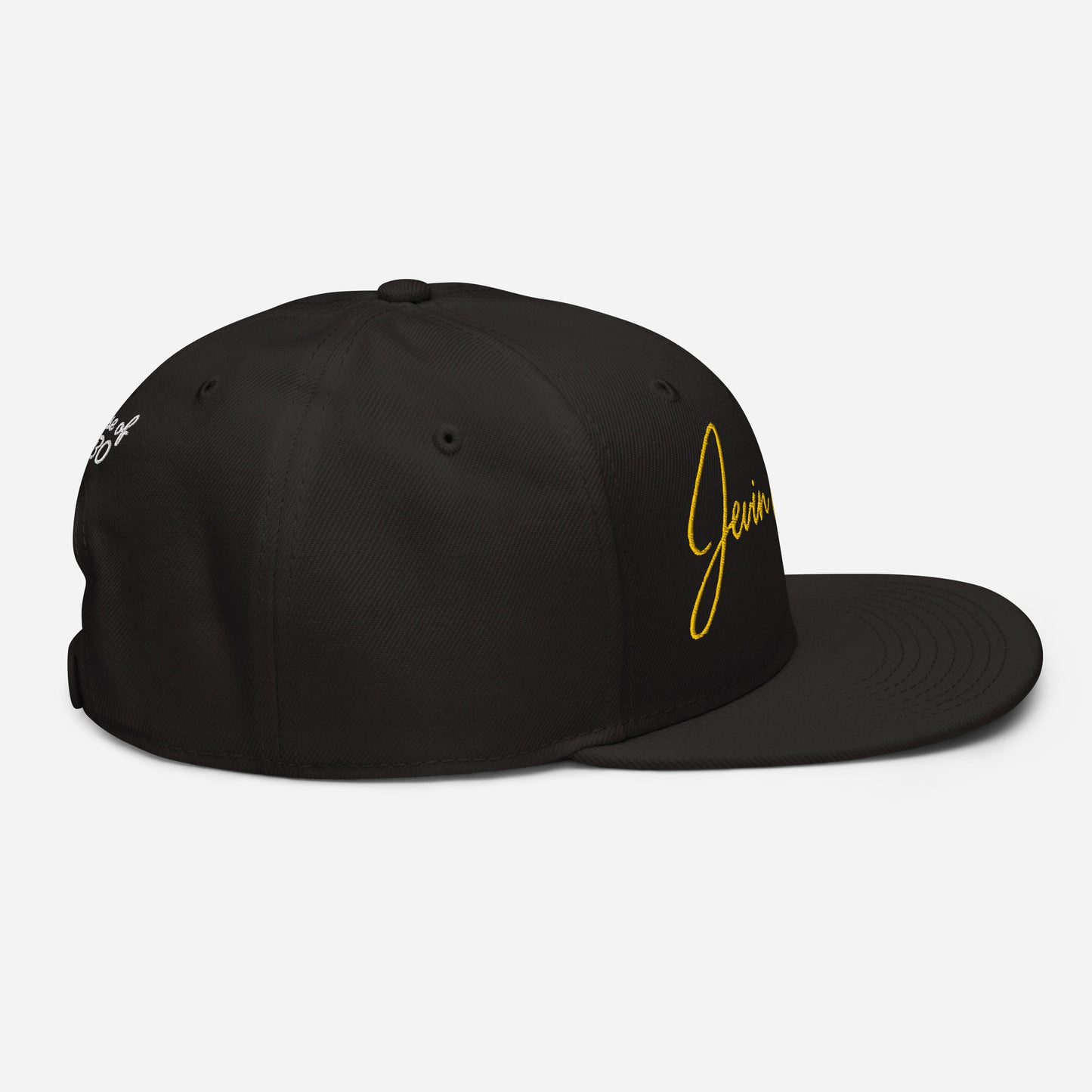 Black snapback cap with small yellow “Jevin” logo on the right side and emblem