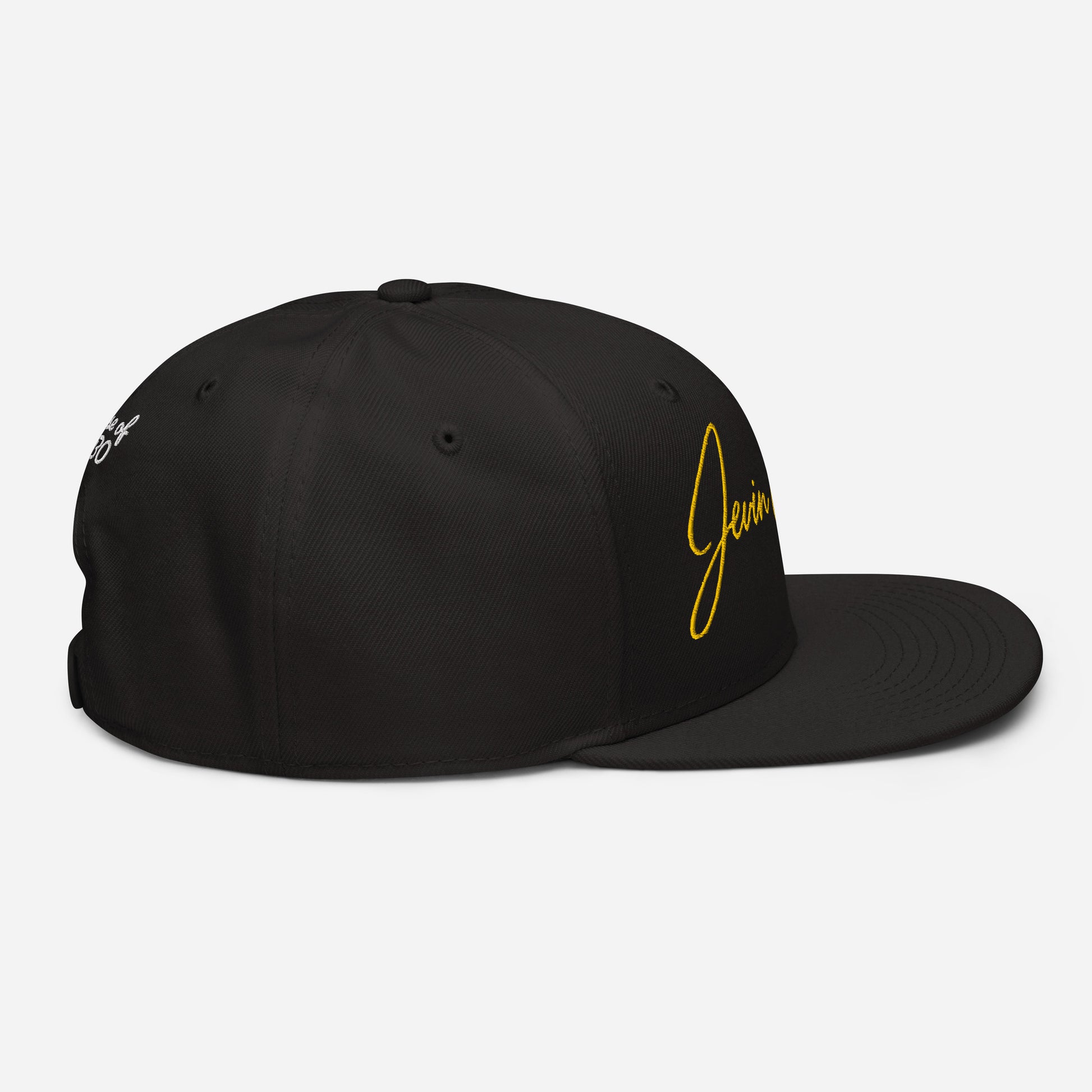 Black snapback cap with small yellow “Jevin” logo on the right side and emblem