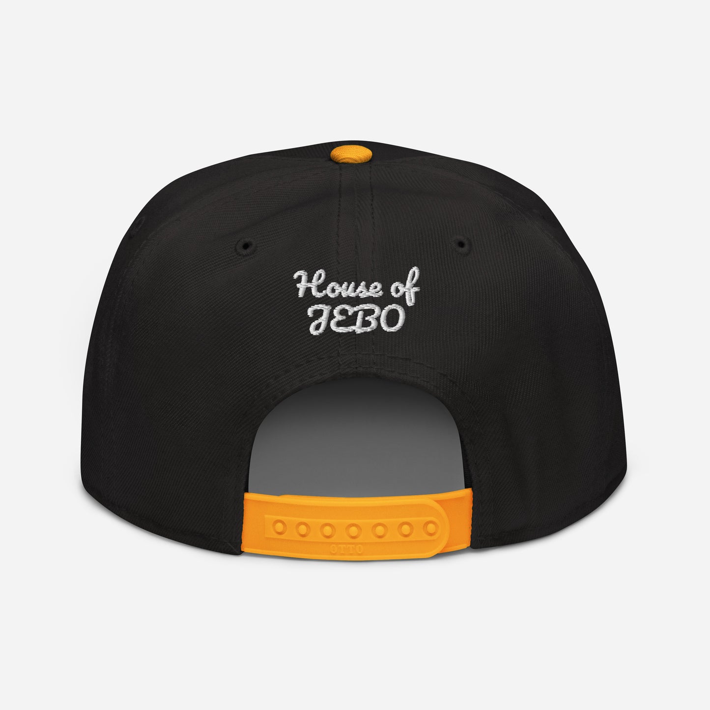 Black snapback cap with orange adjustable strapback and small back logo in white