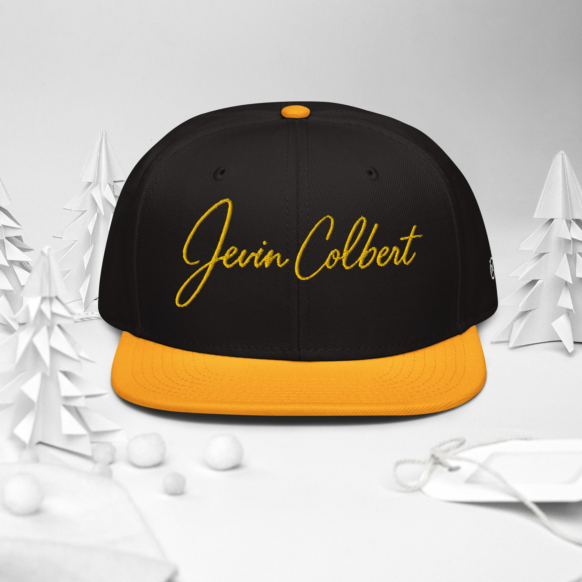 Black snapback cap with Jevin Colbert logo and orange/yellow flat brim