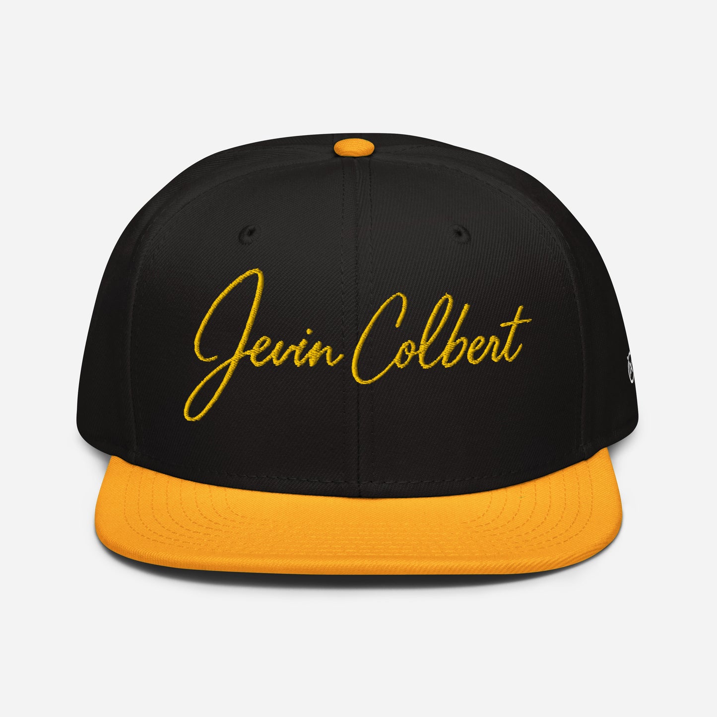 Black snapback cap with orange underside brim and yellow Jevin Colbert logo front