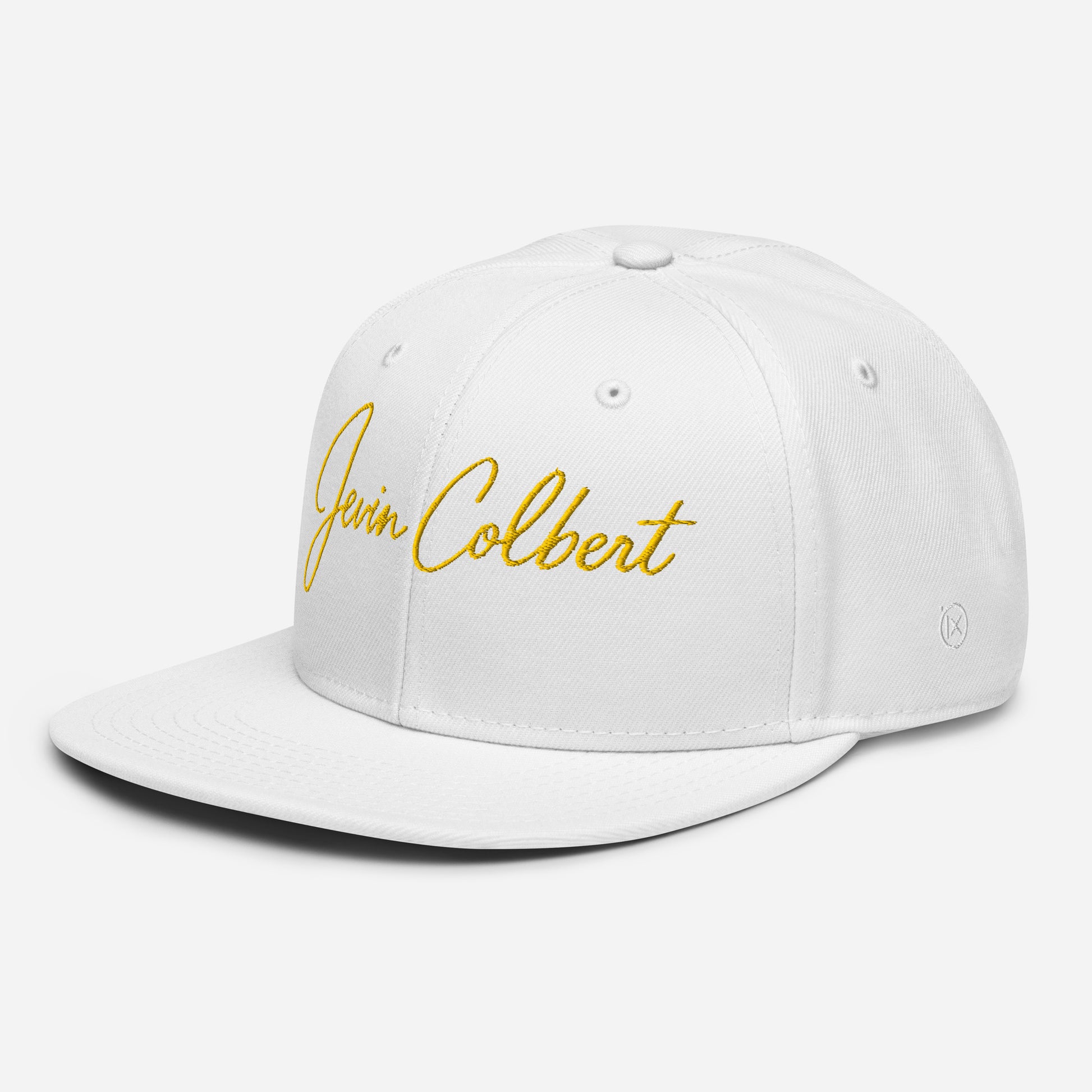 White snapback cap with yellow “Jevin Colbert” script logo on the front, side view