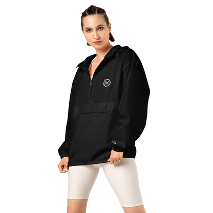 Black anorak windbreaker on model with hood, half-zip front, and elastic cuffs