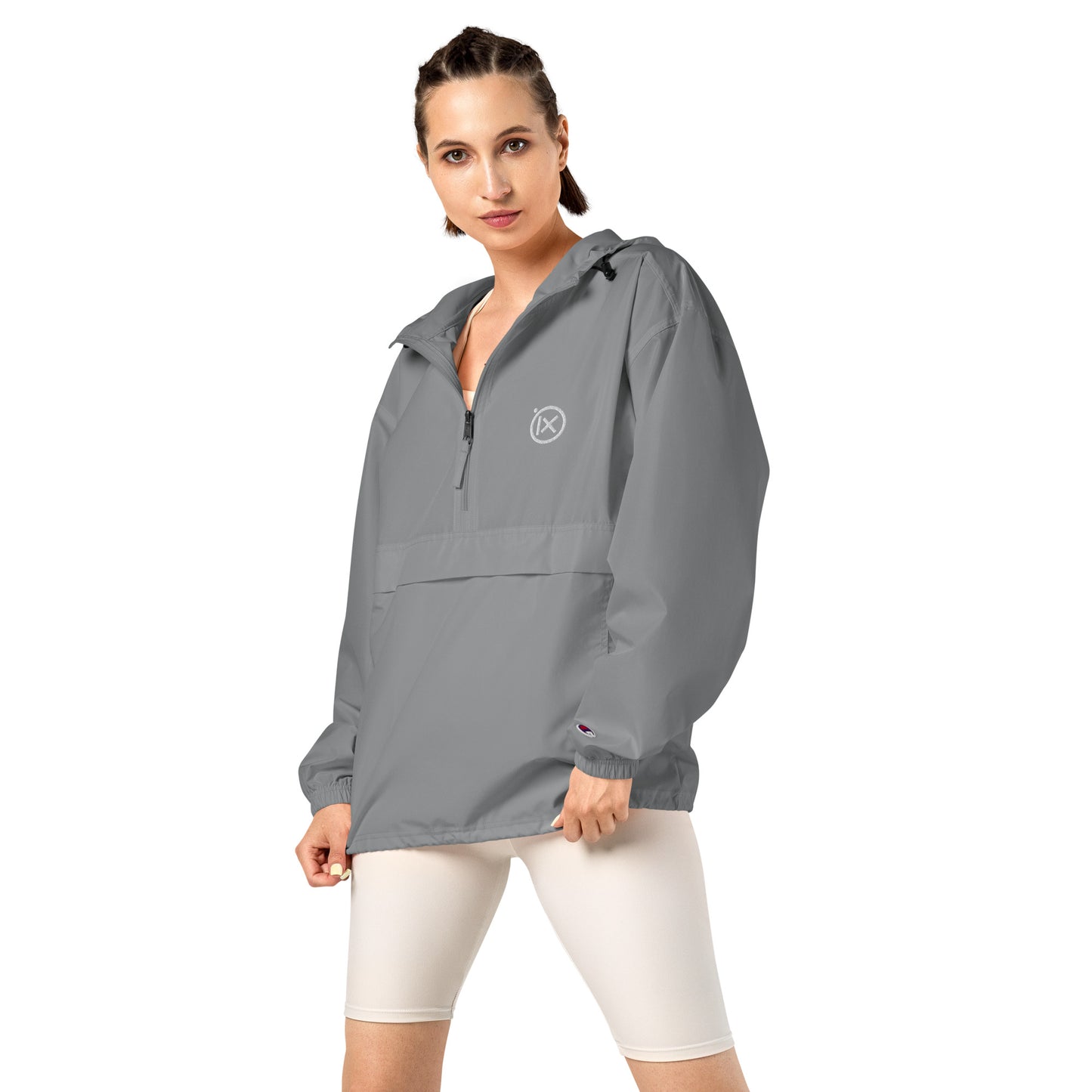 Grey anorak windbreaker on model with hood, half-zip front, and kangaroo pocket