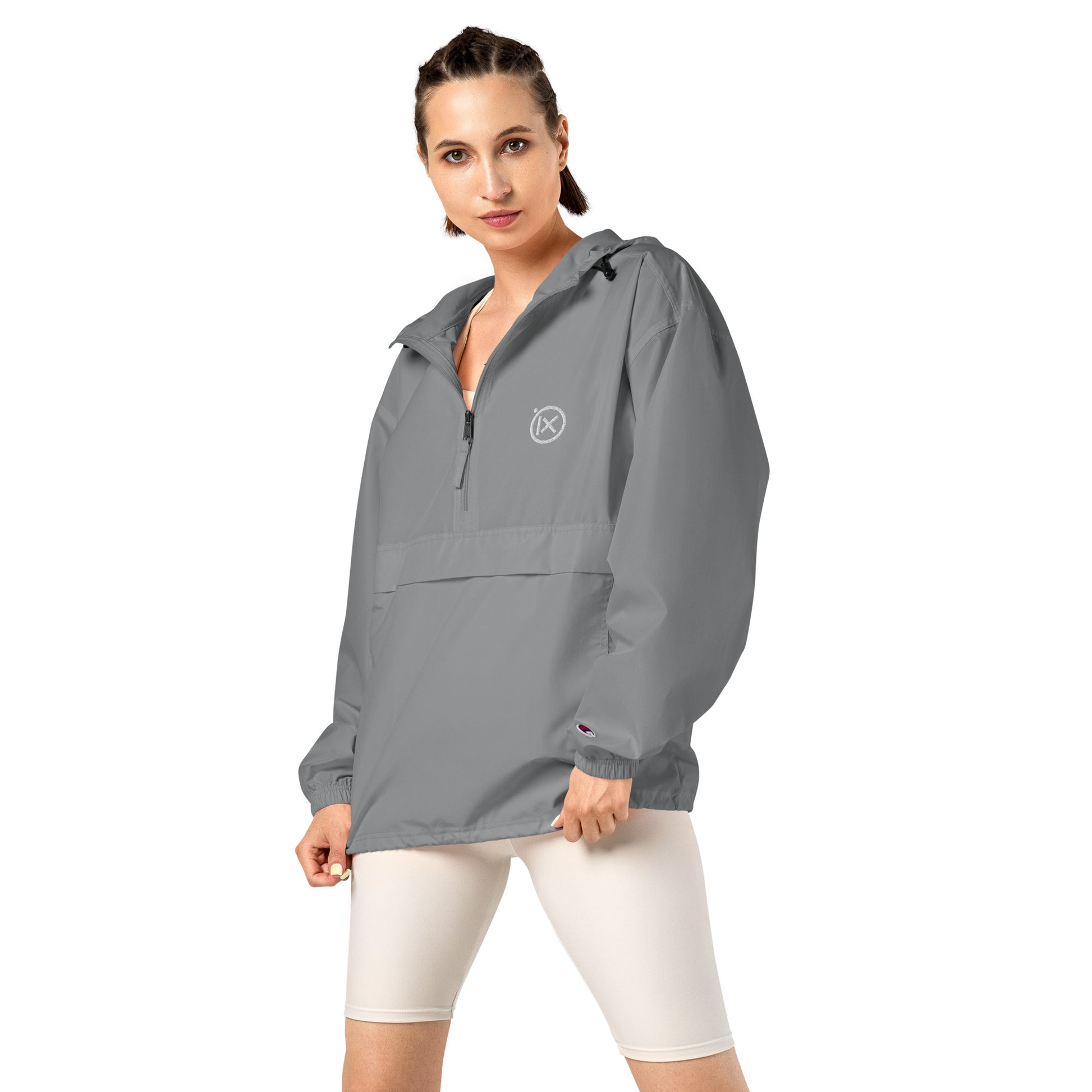 Grey anorak windbreaker on model with hood, half-zip front, and kangaroo pocket