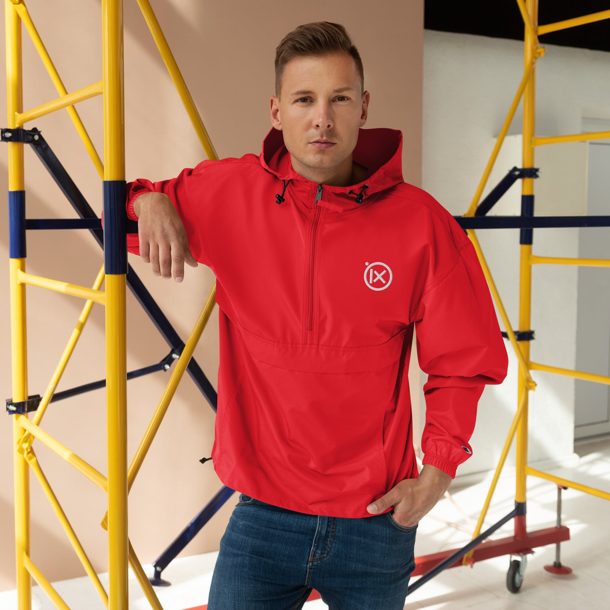 Red anorak windbreaker worn with hood and front zipper