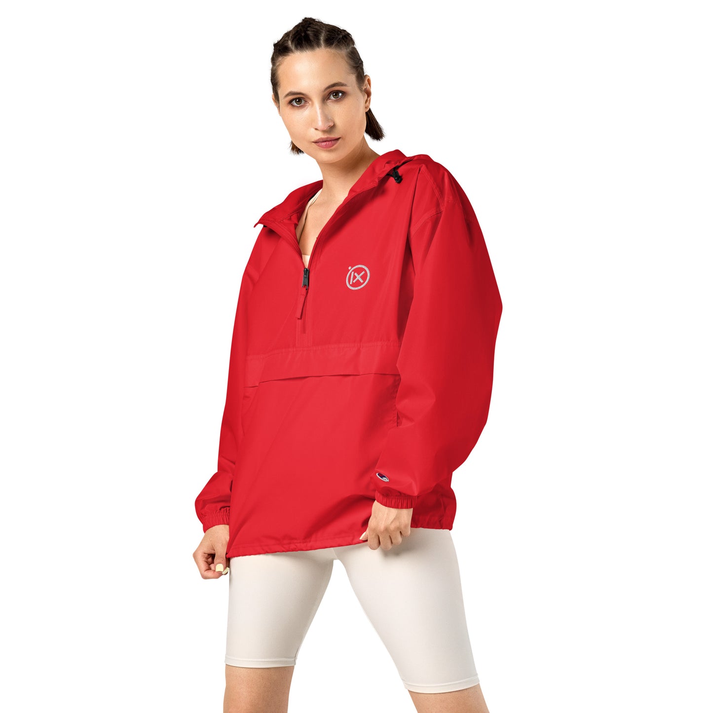 Red anorak windbreaker on model with hood and half-zip front, elastic cuffs