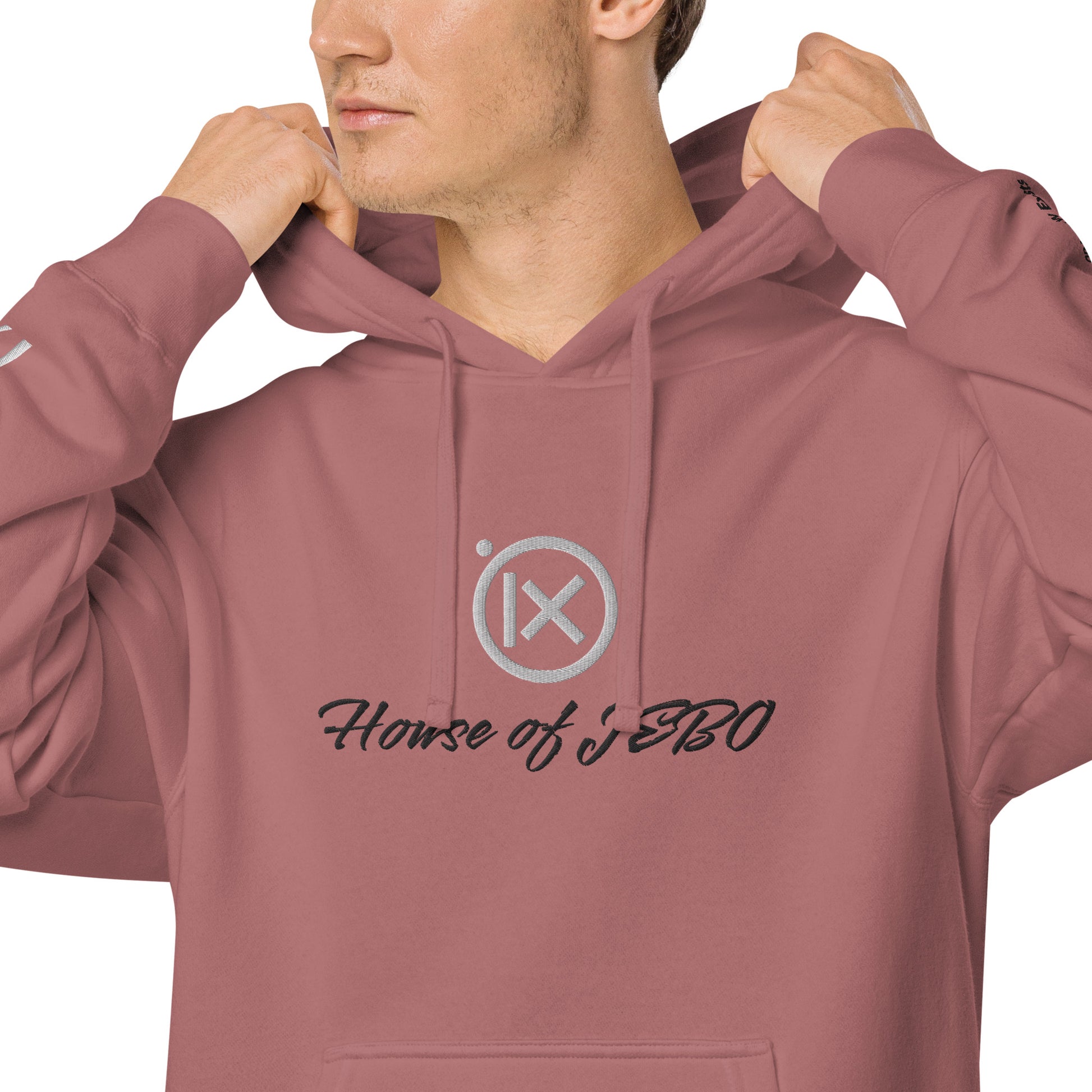 Close-up: dusty rose hoodie with drawstring hood and House of JERO chest graphic