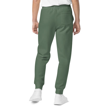 Vintage pigment sweatpants in dark green on model with back pocket detail