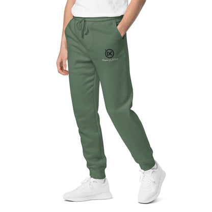 Vintage pigment sweatpants in dark green on model with drawstring waist and logo
