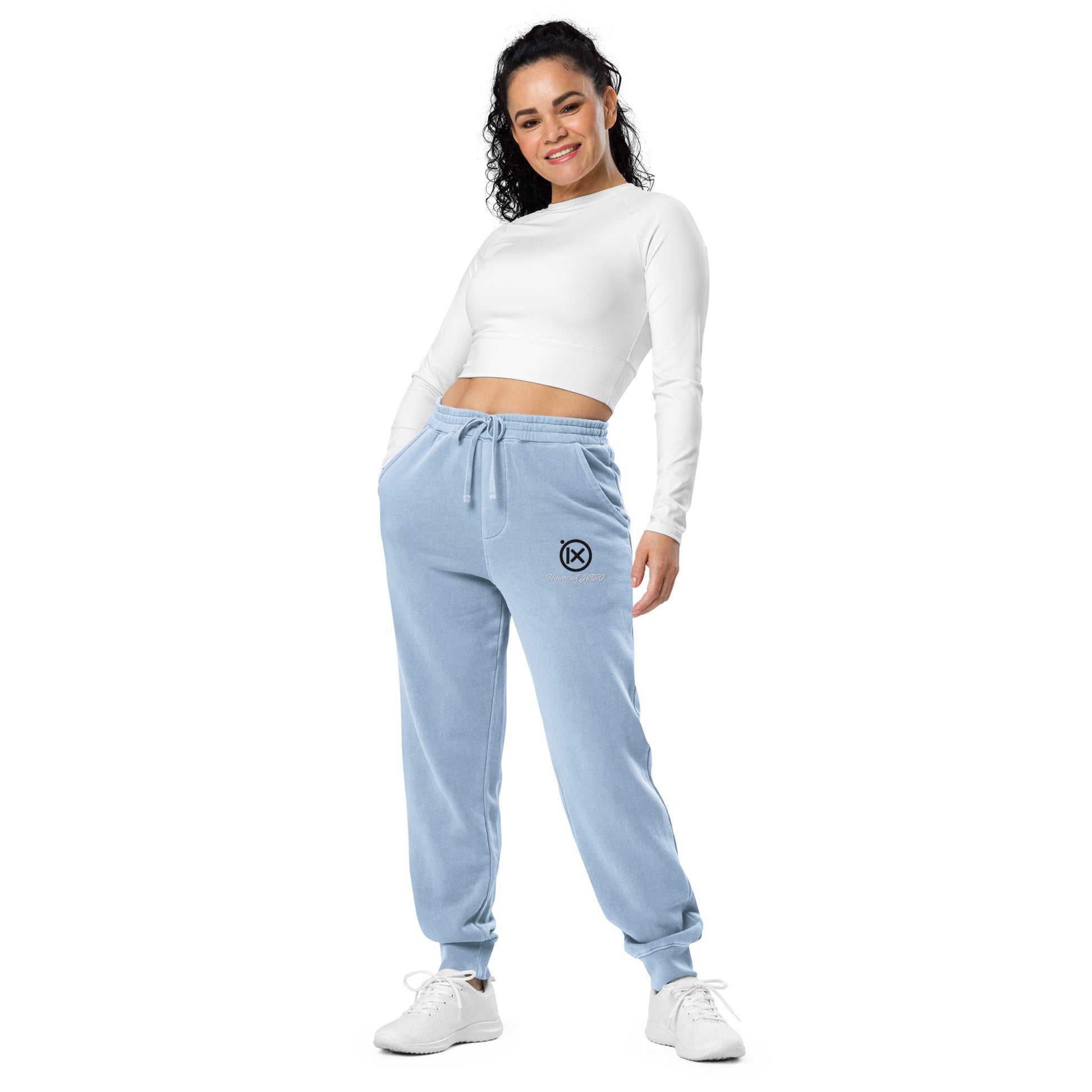 Light blue sweatpants on model, drawstring elastic waist and tapered cuffs