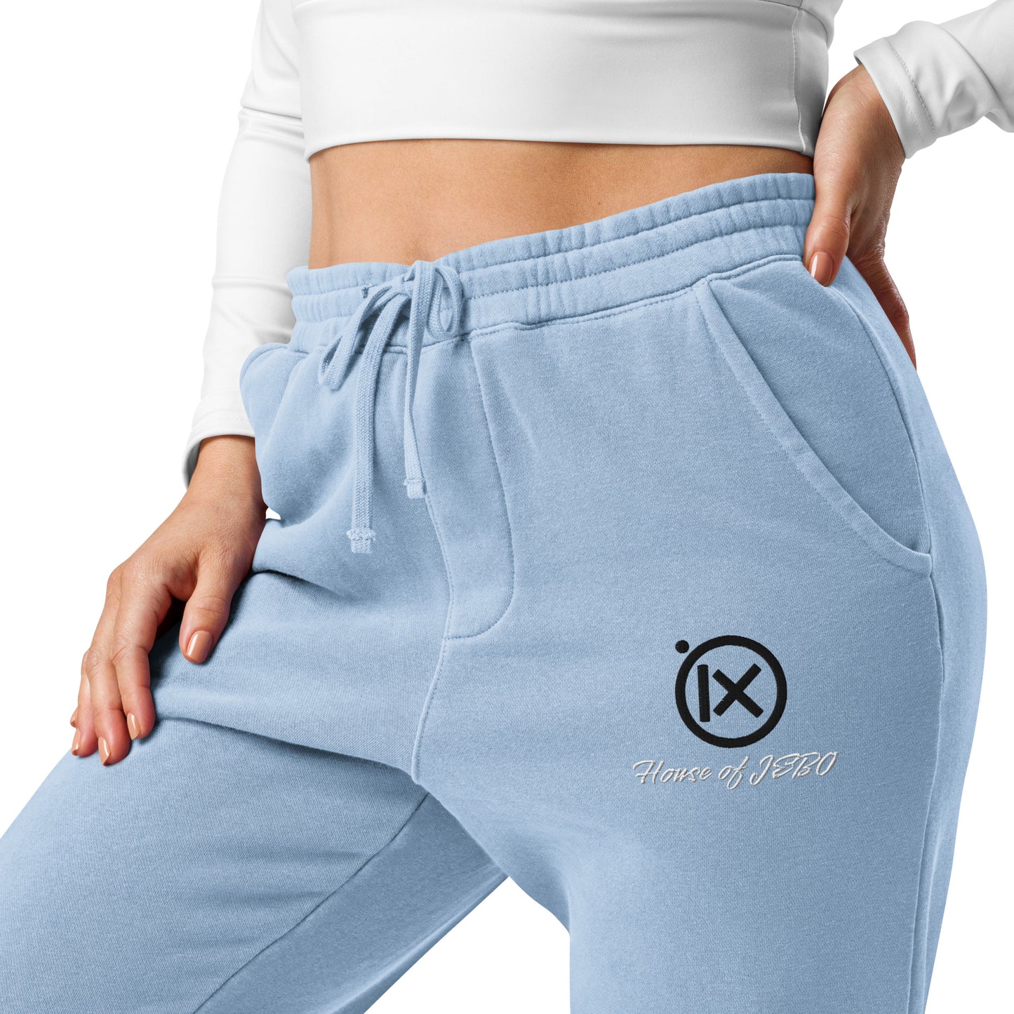 Light blue sweatpants with drawstring waist, embroidered logo, and tapered ankle cuffs
