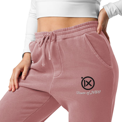 Mauve sweatpants close-up, drawstring waistband and embroidered logo on thigh