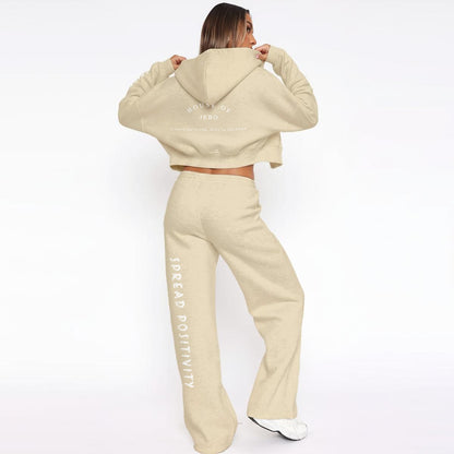 Beige fleece tracksuit: hooded zip hoodie and drawstring wide-leg joggers with side text.